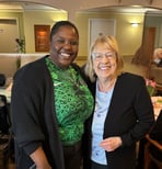 Nurse, Adebusola Oluteye smiles while standing beside a resident she cares for