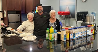 Aspira Kawartha Lakes, Chef Ron Carter  poses with two residents participating in Resident Recipe Day