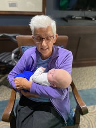 Retired nurse holds baby
