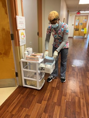 Marian, a psw and IPAC champ re-fills the supply cart