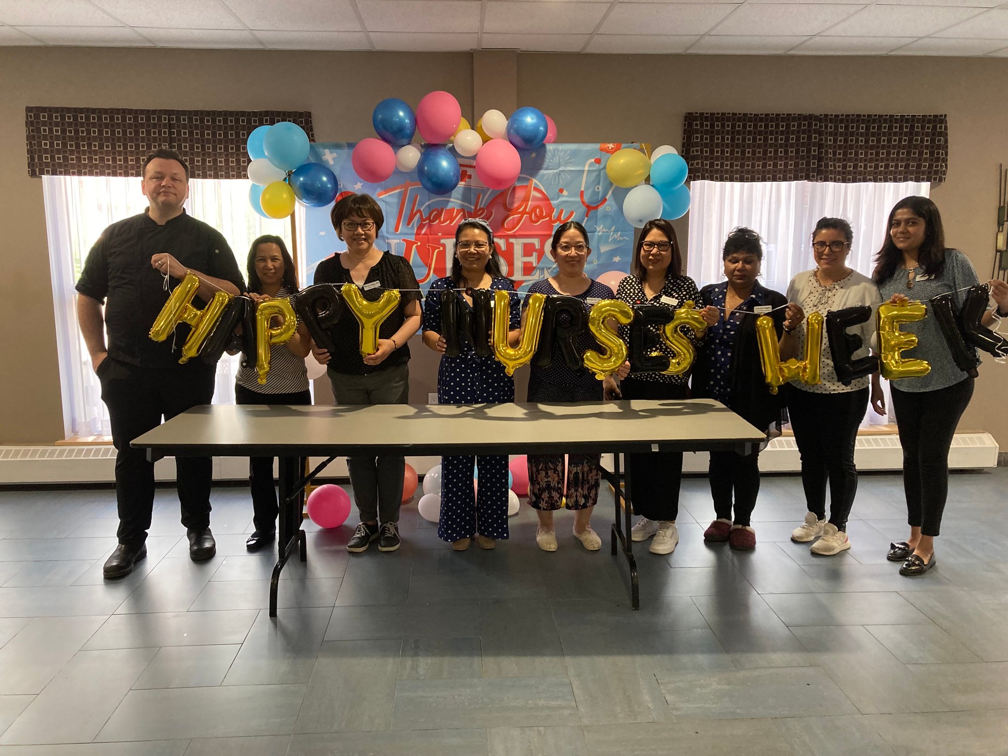 Nurses at Harmony Hills Community holding sign that reads Happy Nurses Week