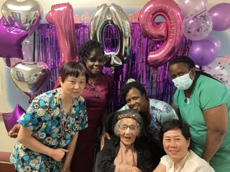 Chiung Hi Chou, celebrating her 109th birthday surrounded by Rockcliffe Team Memebers.